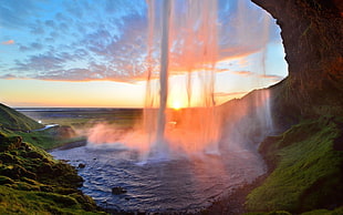 time lapse photography of falls near rock formation