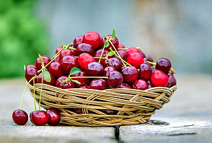 bunch of cherry on white wicker bowl