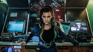 woman wearing blue top standing near desk