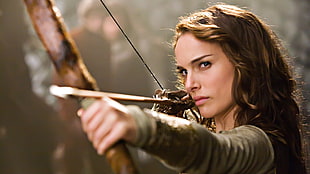 woman holding brown longbow
