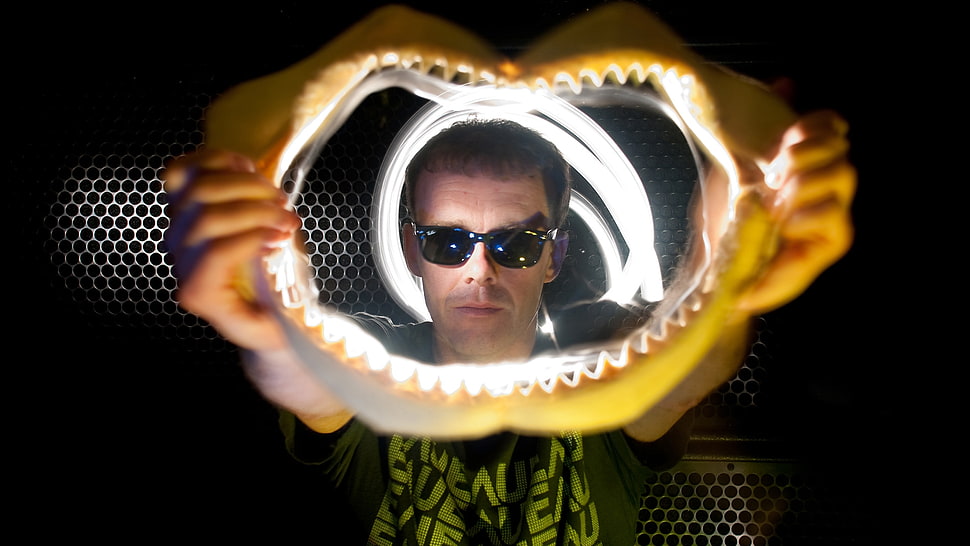 man holding skeletal teeth HD wallpaper