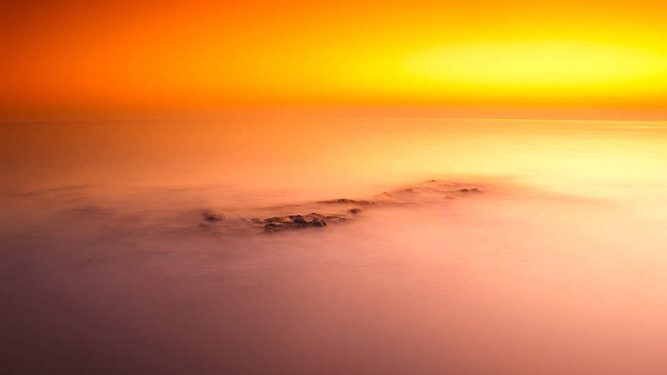 high angle photography of islet covered with fog during golden hour HD wallpaper