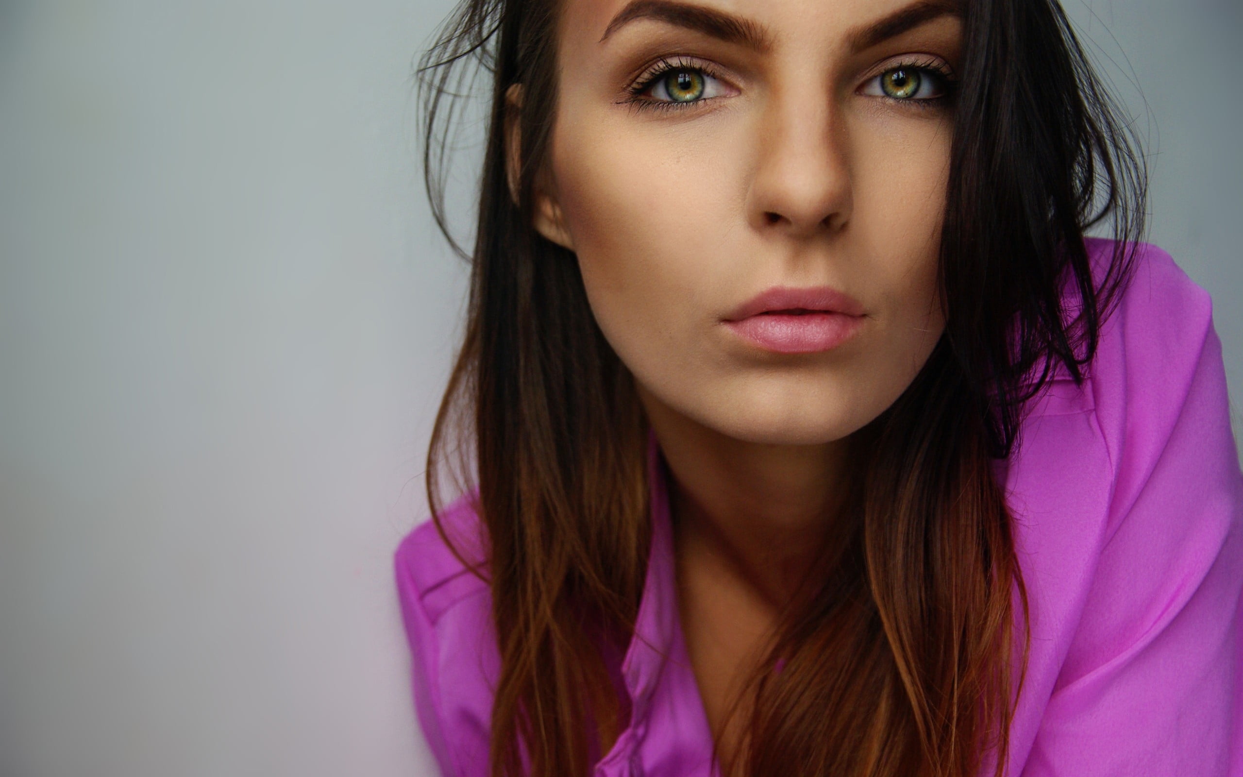 woman with brown hair wearing pink dress shirt