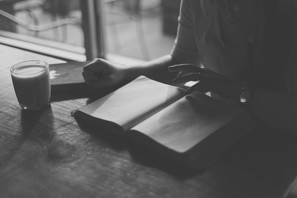 person reading book grayscale photograph HD wallpaper