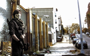 man standing near roll-up door, FN P90, gun, mask, urban HD wallpaper