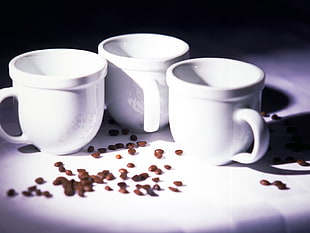 three white ceramic coffee cups in white plate