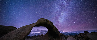 starry night above large rocks HD wallpaper