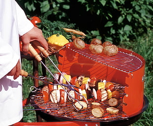 person grilling on charcoal grill