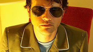 man wearing gray formal coat with aviator sunglasses