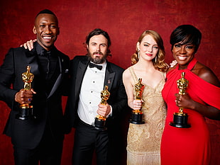 group of stars holding a Oscar trophies