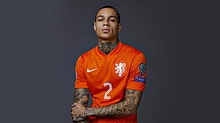 men's orange Nike soccer jersey shirt, footballers, players, tattoo, simple background
