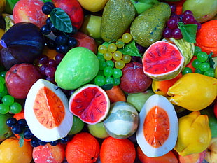 assorted artificial fruits with some sliced artificial vegetables