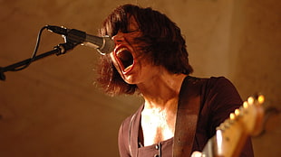 woman wearing black top singing while playing guitar HD wallpaper