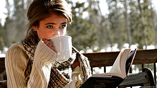 girl wearing sweater and scarf drinking tea