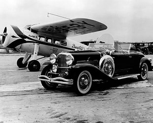 classic black vehicle near airplane, old car, monochrome, airplane