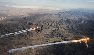 two gray fighter jets chased by heat seeking missiles during daytime HD wallpaper