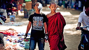 two boy with red robe and black crew-neck top