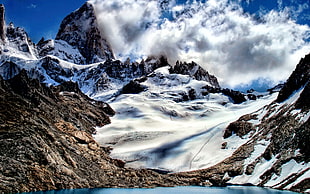 snowy mountain under cloudy blue sky HD wallpaper