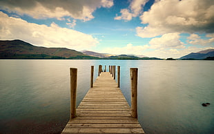 brown wooden table with chairs, pier, dock, water