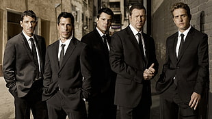 five men in black suits