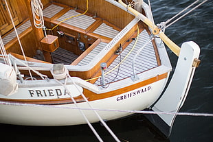 white and brown wooden Frieda boat