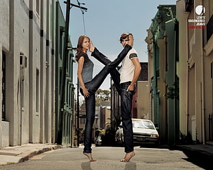 man and woman facing each other with both right legs on shoulders