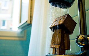 brown wooden figure taking a shower