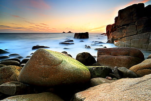 pile of stones on the seashore painting HD wallpaper
