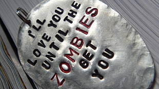 silver-colored pendant, dark humor