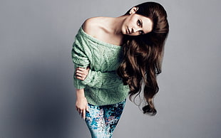 woman wearing green knitted off-shoulder long-sleeved shirt