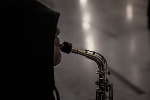 grayscale photo of a man playing a wind instrument
