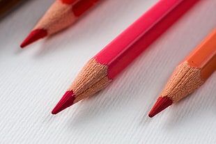 two pink and one orange color pencil HD wallpaper