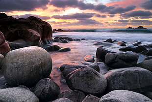 gray stone sea shore in sunset i