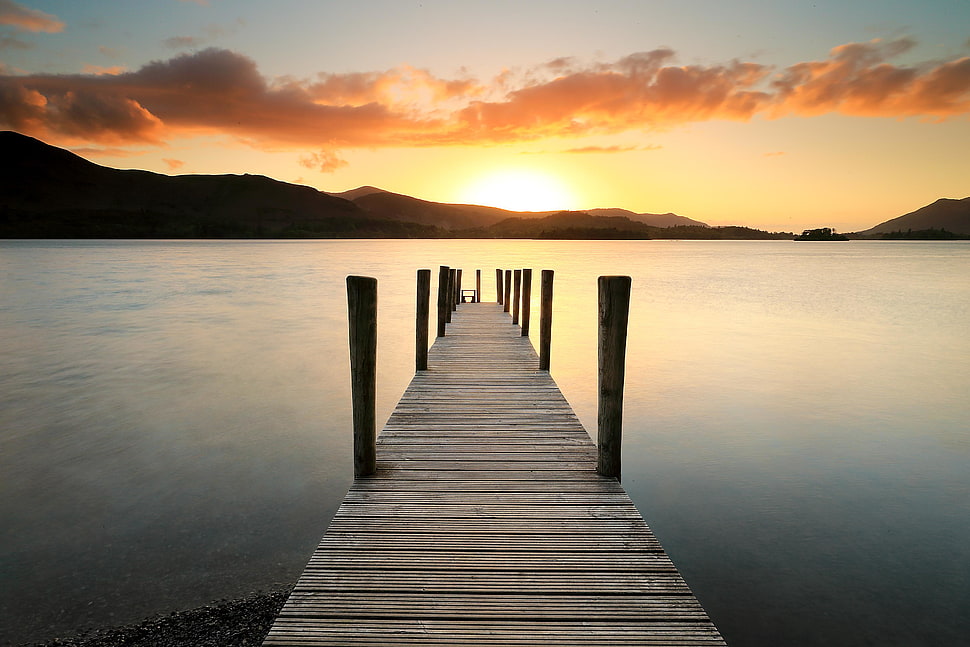brown wooden boardwalk near body of water during sunset HD wallpaper