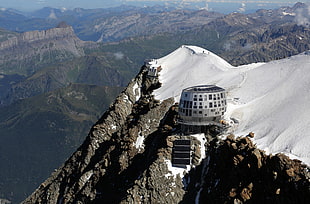 aerial photography of gray concrete building on alps mountain