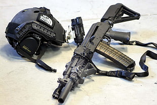 black assault rifle and helmet set HD wallpaper