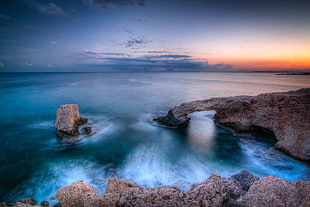 brown rocky mountain by the sea at sunset, protaras, ayia napa, cyprus HD wallpaper