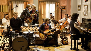 group of people playing music instruments in room