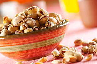 brown peanuts on red ceramic bowl