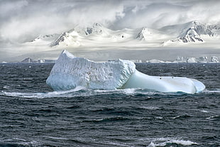 big iceberg float on middle of ocean