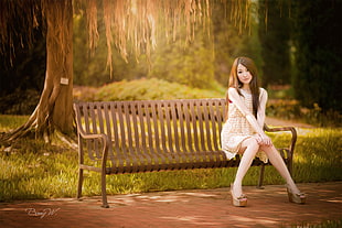 woman in beige dress sitting on bench chair HD wallpaper