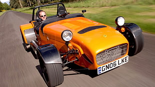 orange and gray 4-wheeled vehicle, car, vehicle, men, men with glasses