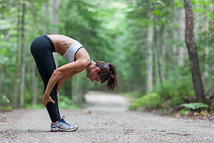 woman stretching in between trees HD wallpaper