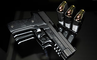 black semi automatic pistol beside bullets