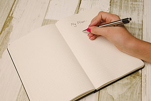 person writing on planner HD wallpaper