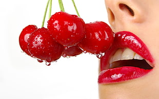 woman eating red cherries HD wallpaper