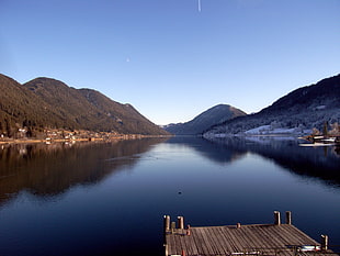 photo of mountain near lake water