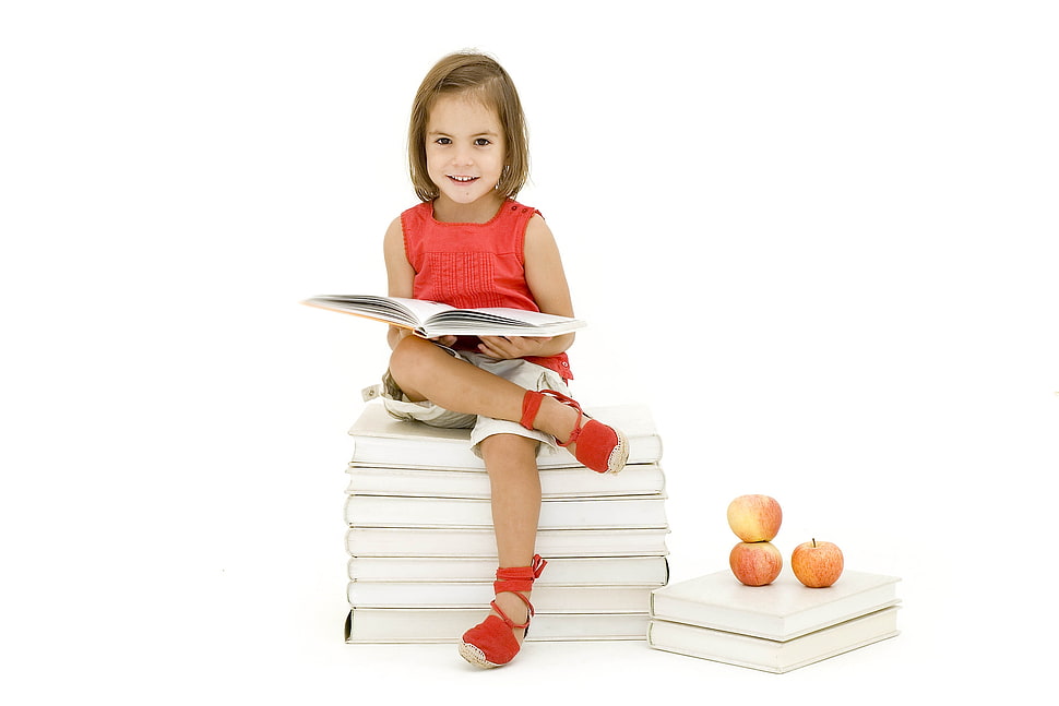 girl in red crew-neck sleeveless dress reading a book HD wallpaper