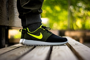 pair of black-yellow-and-white Nike Roshe Run sneakers