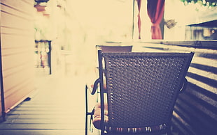 soft focus photography of wicker chair in alley